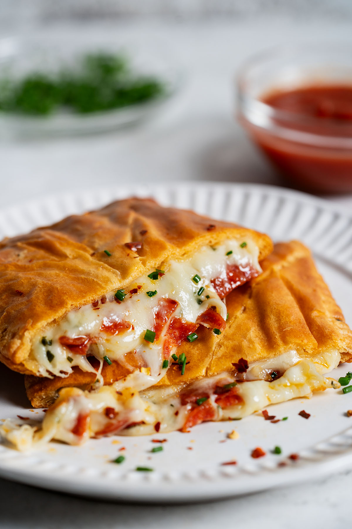 Cross-section of a pizza pocket showing melty cheese and pepperoni