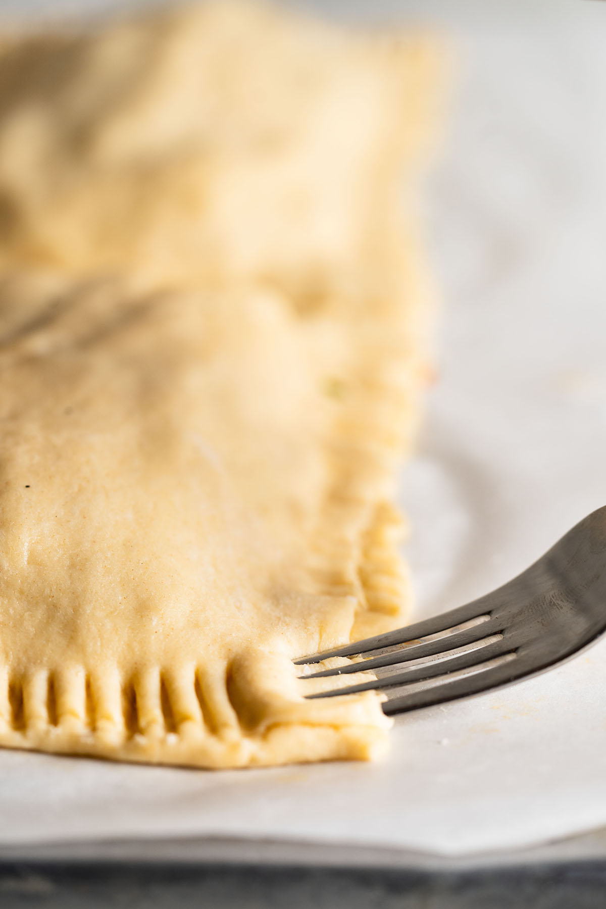 Air Fryer Pizza Pocket step by step instructions of pizza pocket edges being crimped.