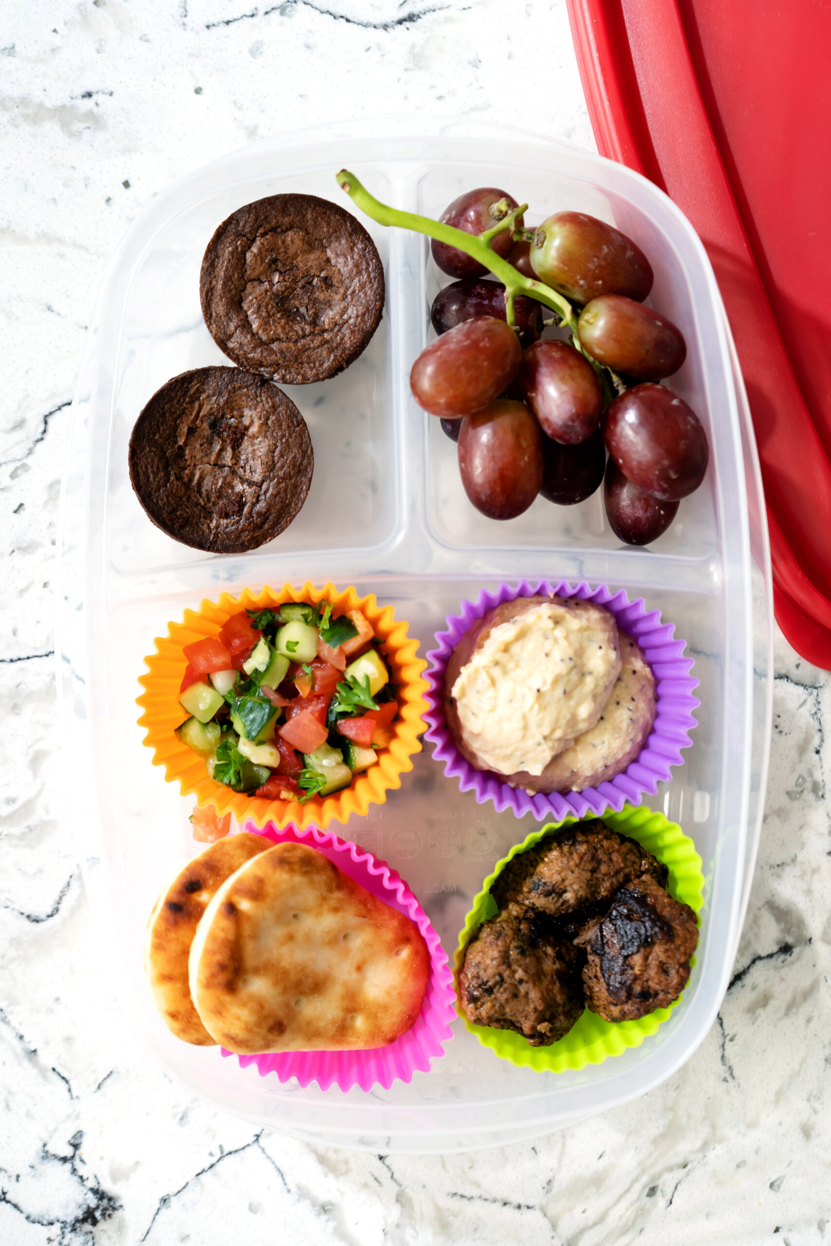 Mediterranean Lunchable with pita wedges, hummus, cucumbers, olives, and feta.