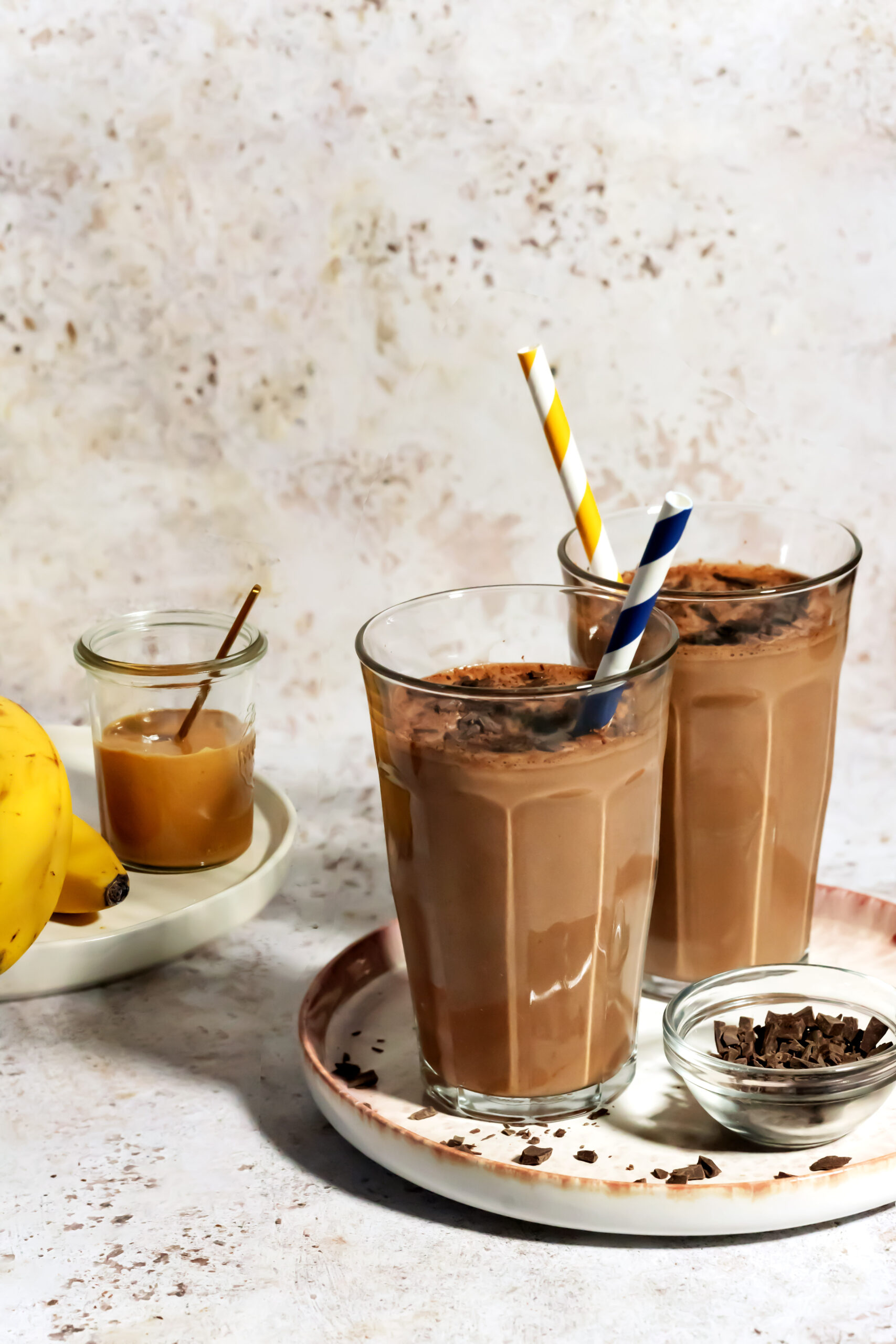Chocolate peanut butter protein shake in a clear glass