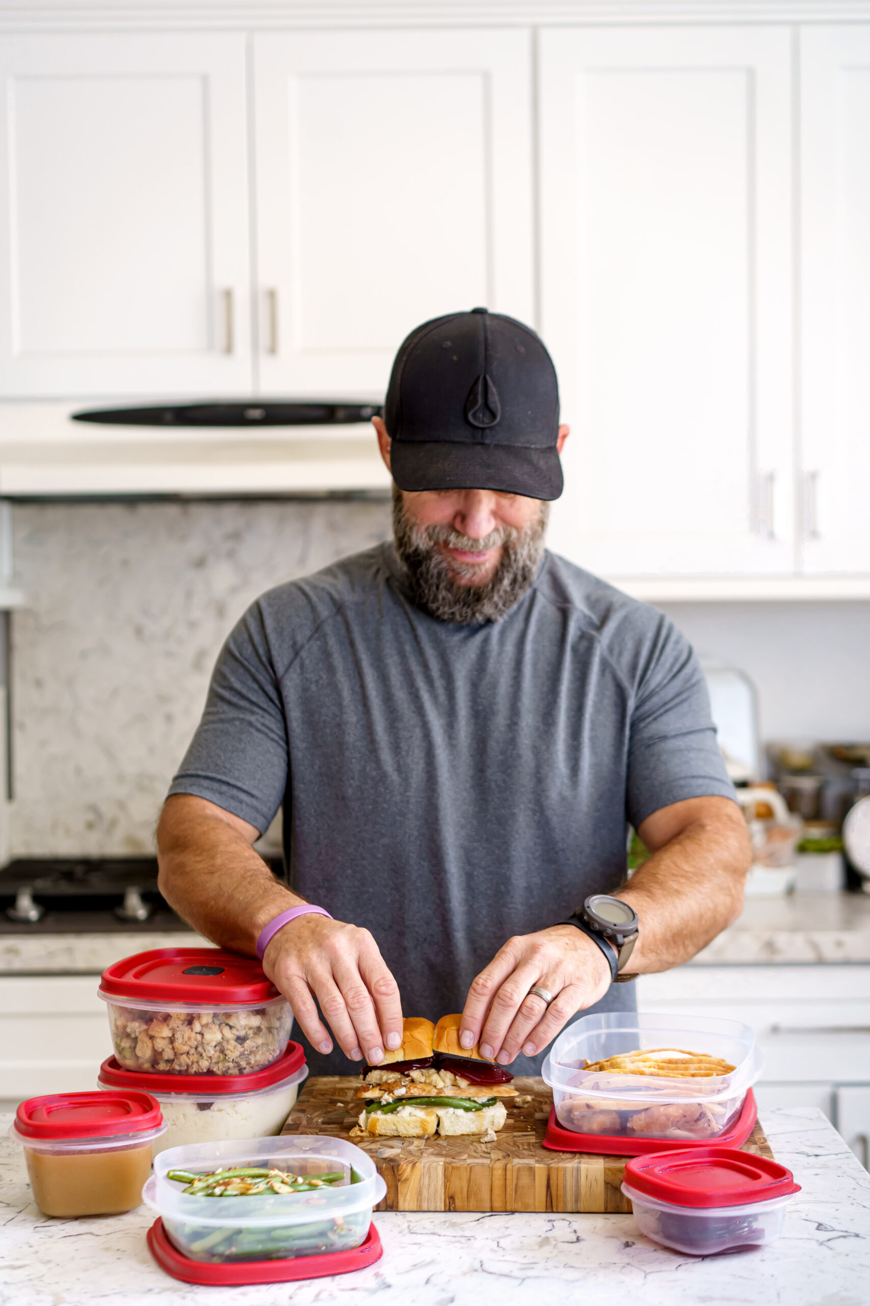 Thanksgiving leftover sliders stacked on a sweet roll, dripping with gravy and cranberry sauce.