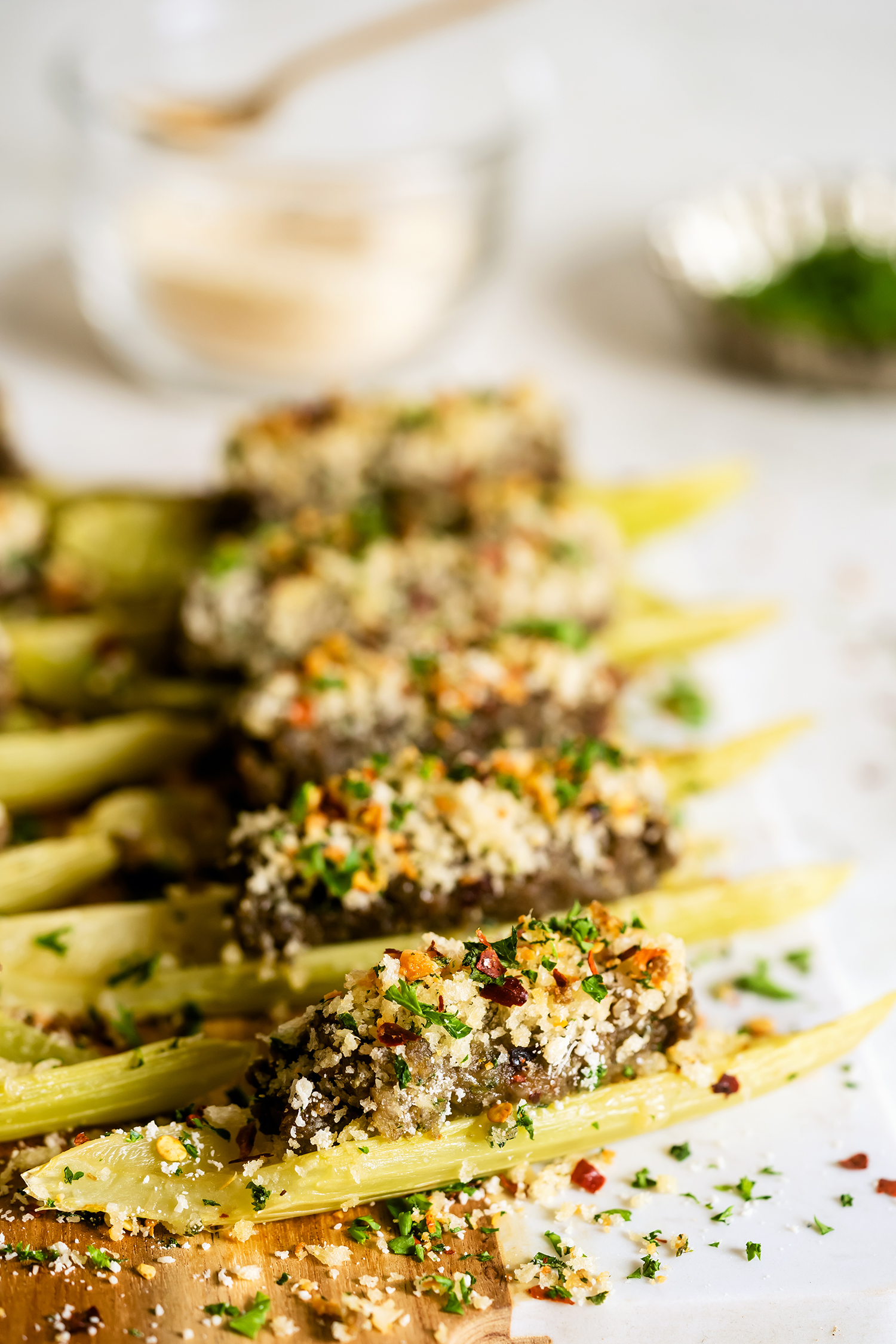 Stuffed celery boats on a wooden board with garnishes